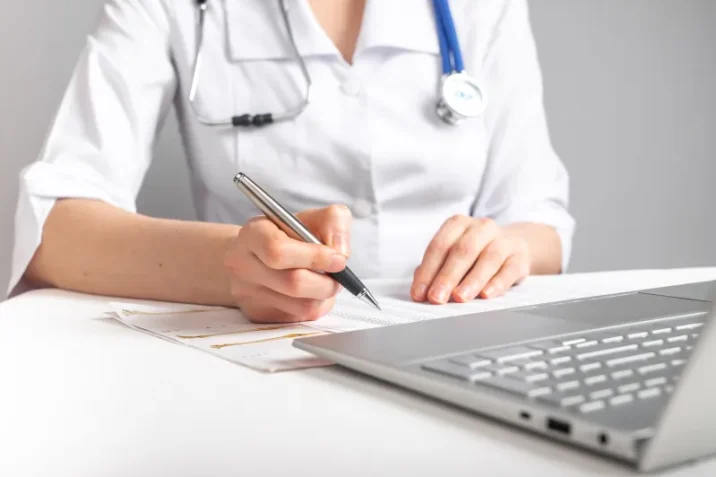 jpeg_Doctor-checking-paper-with-pen_5856x4160px-scaled